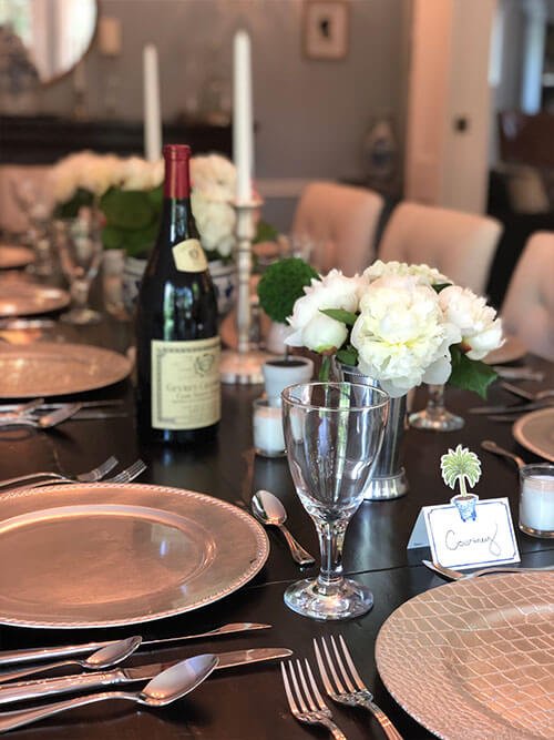 Photo of a table with place settings and wine